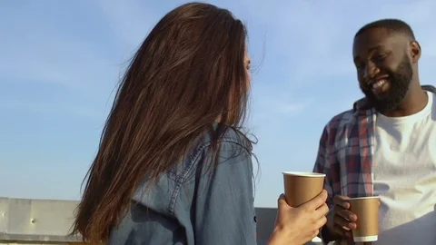 Cheerful multiethnic colleagues drinking coffee and communicating during break Stock-Footage 117196044