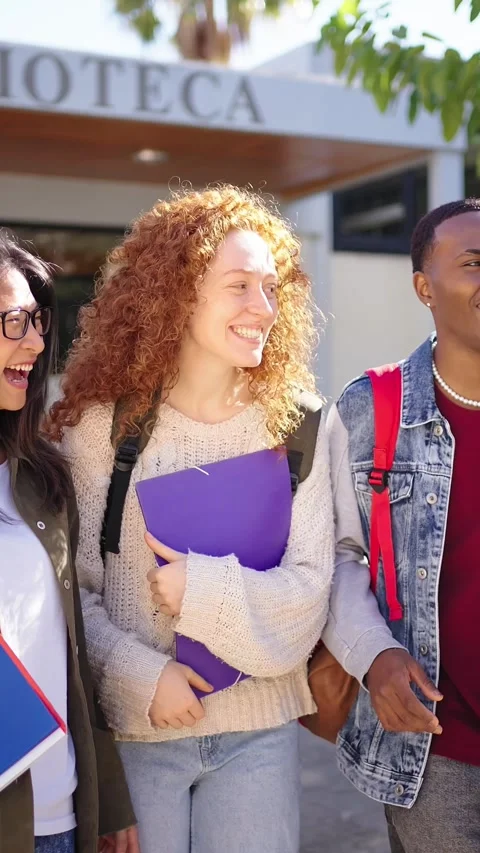 Cheerful multiracial group of young students leaving the library building Stock Footage 268645275