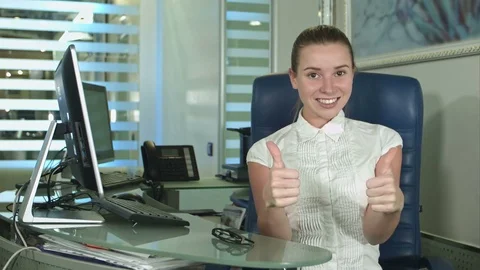 Cheerful office-worker showing thumbs up looking at camera Stock-Footage 80077128