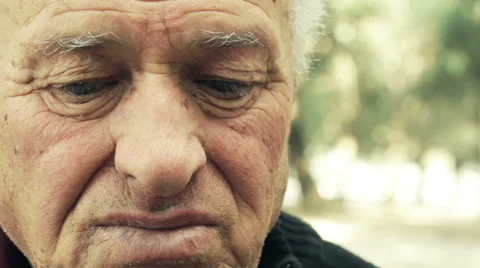 Cheerful old man sitting alone: closeup portrait in the park, deep in thoughts  Stock Footage 48058203
