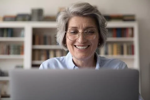 Cheerful older business teacher woman in stylish glasses Stock Photos