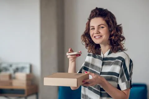 Cheerful online store worker posing for the camera in the workplace Stock Photos