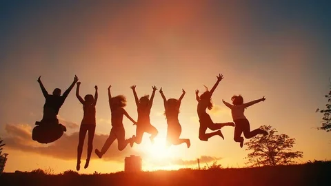 Cheerful People Jumping at Sunset Stock Footage 81157889