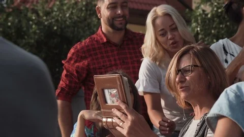 Cheerful people watching photos Stock Footage