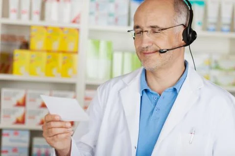 Cheerful pharmacist using headset Stock Photos