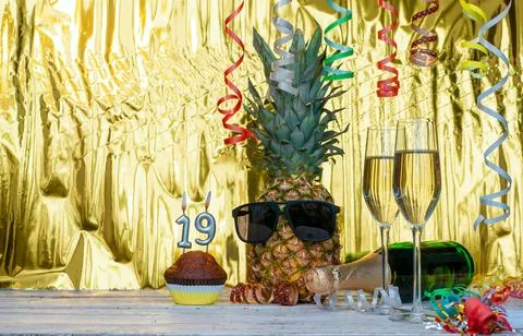Cheerful pineapple in glasses festive happy birthday character with number .. Photos