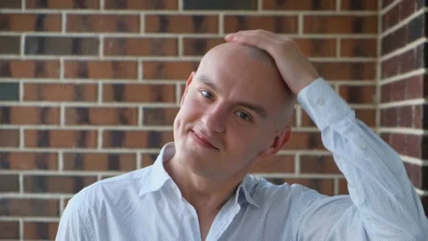 Cheerful positive bald man stroking his bald head, close-up Stock Footage 201212865