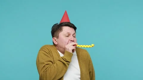 Cheerful positive middle aged man in party hat and white t-shirt with cardigan Stock Footage 150530926