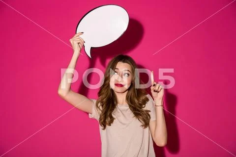 Cheerful pretty young woman holding speech bubble Stock Photos