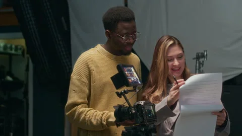 Cheerful Production Crew Checking Script before Going on Air Video stock 309317620