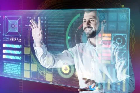 Cheerful programmer looking glad while working with a transparent device 스톡 사진