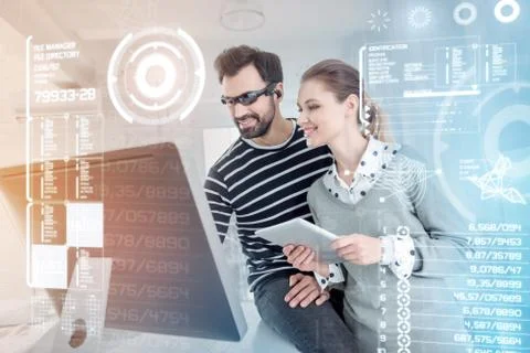 Cheerful programmers looking at the screen of their computer and feeling glad Foto stock