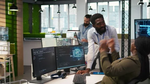 Cheerful programmers in office enjoying conversation while automating with AI Stock-Footage 313017159