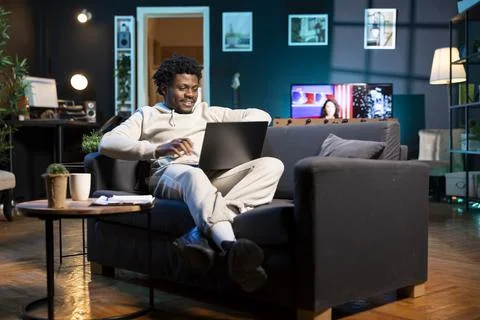 Cheerful remote worker checking his emails on laptop Stock Photos