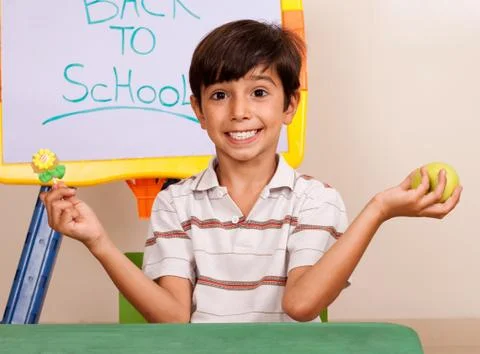 Cheerful school boy holding an apple Stock Photos