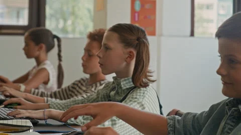 Cheerful Schoolboys Looking at One Another at Programming Lesson and Smiling Stock Footage 316479140