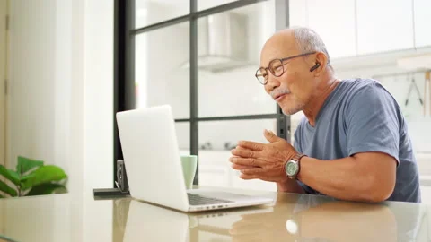 Cheerful senior man making video call on laptop Stock Footage 219837009