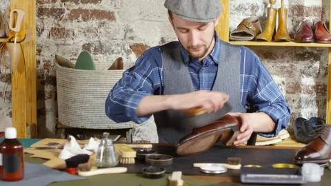 Cheerful Shoemaker Posing for Camera at Work Desk in Studio Video stock 103586776