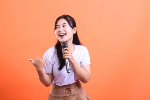 Cheerful singer with microphone Stock Photos