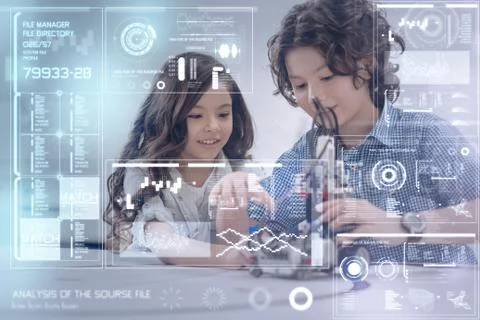 Cheerful smart children smiling while constructing together Stock Photos