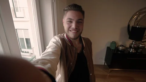 Cheerful smiling guy speaking to camera Stock Footage 101026665