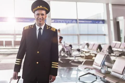 Cheerful smiling pilot in terminal Stock Photos