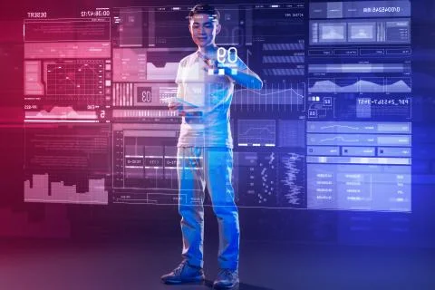Cheerful software developer standing opposite screen transparent device Foto stock