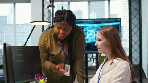 Cheerful startup manager satisfied with progress of intern learning to use AI Stock Footage 313165417