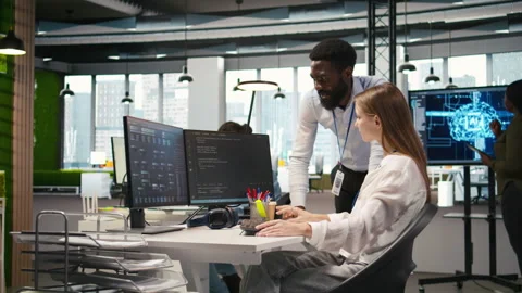 Cheerful startup manager satisfied with progress of intern learning to use AI Stock Footage 313168251