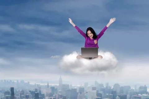 Cheerful student with laptop on cloud Foto stock