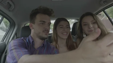 Cheerful students having fun when they travel in the car taking selfie pics a Video stock 102109502