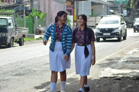 Cheerful Students Walking Together Talking Happily Along Busy Roadside Street Stock Photos
