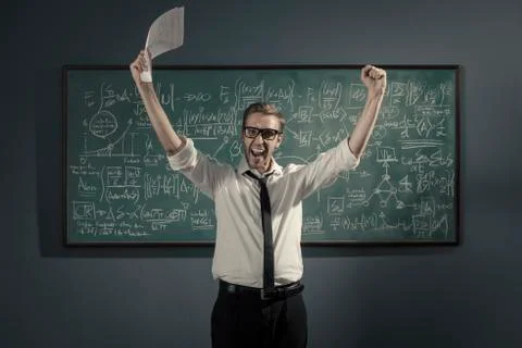 Cheerful successful mathematician solving a problem and celebrating Stock Photos