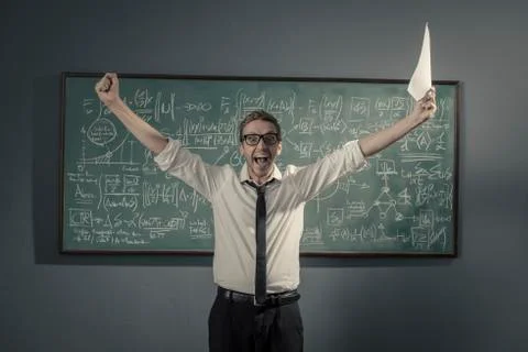 Cheerful successful mathematician solving a problem and celebrating Stock Photos