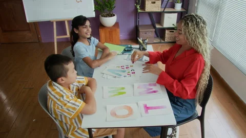Cheerful Teacher Conducting Lesson of Speech Therapy to Diverse Kids Stock Footage 282958331