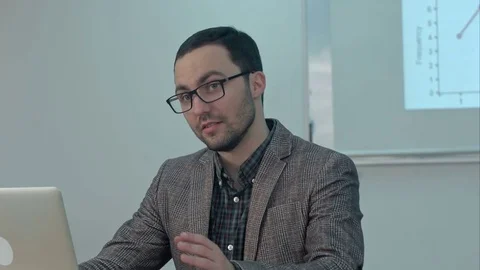 Cheerful teacher working on laptop in education class Stock Footage