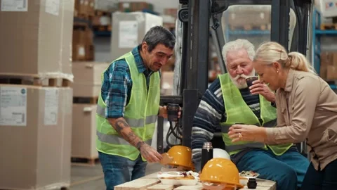 Cheerful team of workers at the workplace in the warehouse toasting Stock Footage 166704504