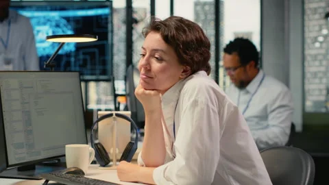 Cheerful technician working in office, using AI specialized hardware 動画素材 322700889