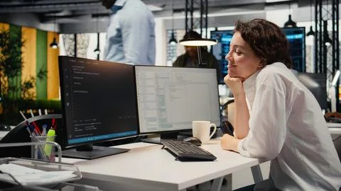 Cheerful technician working in office, using AI specialized hardware Stock Photos