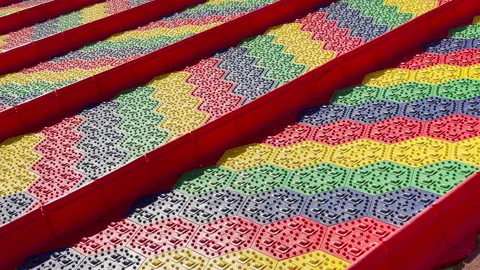 Cheerful Textured Slides Wait Silently in a Vibrant Sunlit Zoo Play Area Stock Footage 334512810