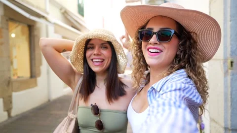 Cheerful tourists taking selfie while walking down street Stock Footage 311597214