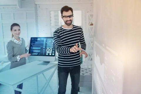 Cheerful web developer wearing virtual reality glasses and smiling Stock Photos