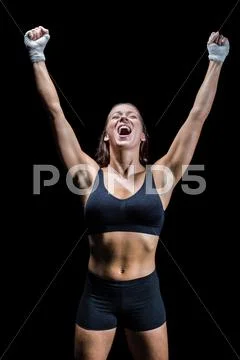 Cheerful winning athlete against black background Stock Photos
