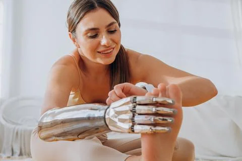 Cheerful woman with bionic arm does stretching exercises Stock Photos
