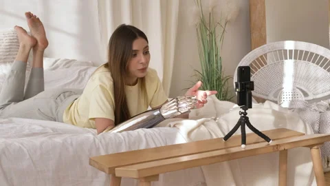 Cheerful woman with bionic arm has video call on smartphone Stock Footage 150241648