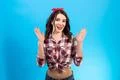 The cheerful woman gesturing on the blue background Photo