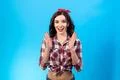 The cheerful woman gesturing on the blue background Photo