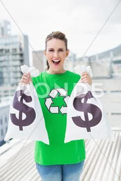 Cheerful woman in green recyling tshirt showing money bags Stock-Fotos