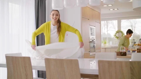 Cheerful woman setting the table  Stock Footage 86423933