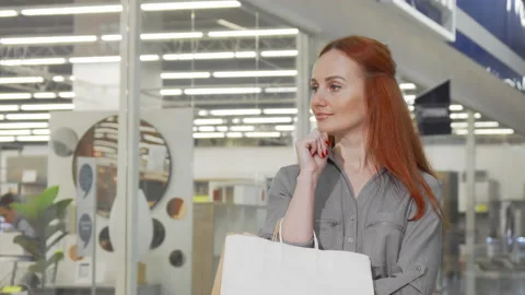 Cheerful woman smiling to the camera while shopping at the mall Stock-Footage 147899645